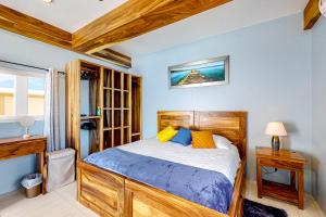 a bedroom with a wooden bed and a window at The Lor-E-Lei House in San Pedro