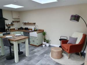 a kitchen with a table and chairs in a room at Birchwood Bothy in Pitlochry