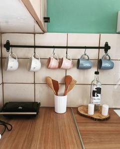 a kitchen with pots and pans hanging on a wall at Io the cosy home Plomari in Plomari