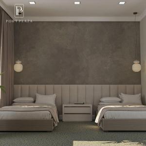 a bedroom with two beds and a wall at Port Plaza YVN in Pʼarakʼar