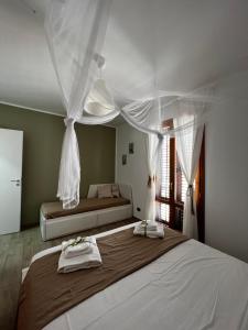 a bedroom with a large bed with towels on it at sicily home casa vacanze con piscina in San Vito lo Capo +51 photos