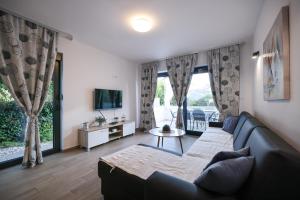 a living room with a couch and a tv at Apartments Mato in Zadar