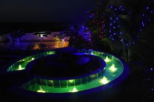 a night view of a fountain with christmas lights at H P HomeStay in Dhārwād
