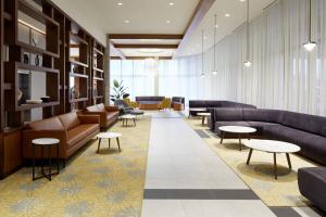 a waiting area with couches and tables in a lobby at Residence Inn by Marriott Montreal Midtown in Montréal