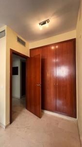 a large wooden door in a room with a hallway at Work and Rest Away From Home in Paterna