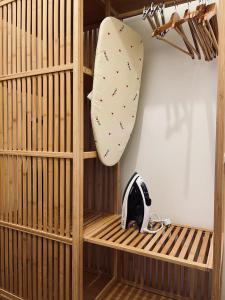 a wooden shelf with a surfboard and a helmet on it at Loft Poerio Ostuni in Ostuni
