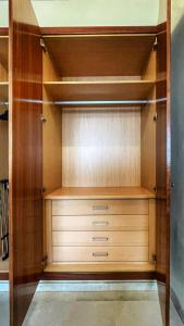 a walk in closet with wooden shelves and cabinets at Work and Rest Away From Home in Paterna
