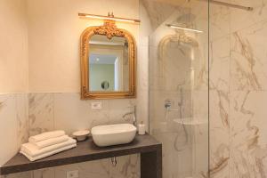 a bathroom with a sink and a shower with a mirror at Leopoldo in Baveno +23 photos