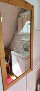 a bathroom with a sink and a mirror at Gästehaus Alte Liebe in Borgholzhausen