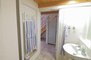 a white bathroom with a sink and a shower at Ferienhaus- die KATE in Barth am Bodden in Barth