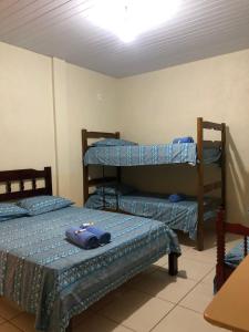 a room with three bunk beds in it at Pousada Sitio Preguicas in Barreirinhas