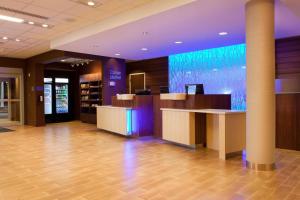 a lobby with a reception desk in a building at Fairfield Inn & Suites by Marriott Lethbridge in Lethbridge