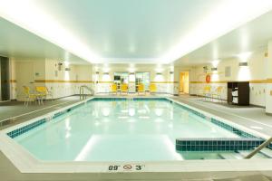 a large swimming pool in a large building at Fairfield Inn & Suites by Marriott Lethbridge in Lethbridge