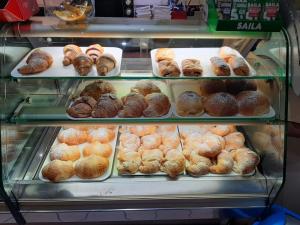 a display case filled with lots of different types of donuts at B&B NONNO MICHELE in Fisciano