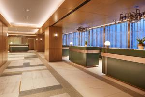 a lobby with reception desks and windows in a building at Sheraton Centre Toronto Hotel in Toronto