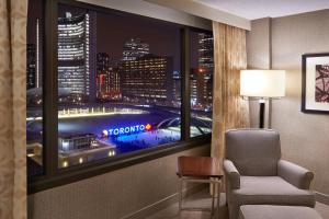 a room with a window with a view of a city at Sheraton Centre Toronto Hotel in Toronto