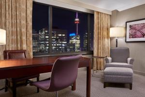 a room with a desk and a chair and a window at Sheraton Centre Toronto Hotel in Toronto