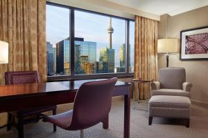 a hotel room with a desk and chair and a window at Sheraton Centre Toronto Hotel in Toronto