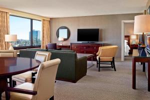 a living room with a couch and a television at Sheraton Centre Toronto Hotel in Toronto