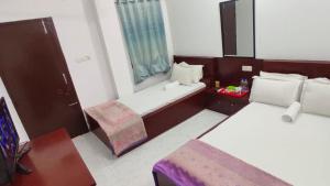 Postel nebo postele na pokoji v ubytování Hotel Muna Dhanmondi Six Floor