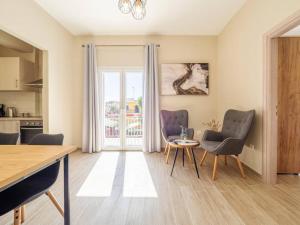 a living room with a table and two chairs at Sandra's Beach House in Gouvia