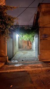 an alley way with a building with a light at night at Tamara`s Apartament in Avlabari in Tbilisi City
