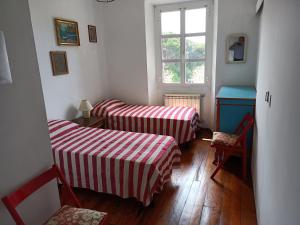 a room with two beds and a window at Splendid Villa Sea View Alassio in Alassio