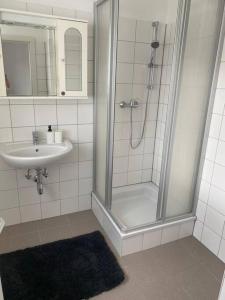 a bathroom with a shower and a sink at Ruheoase zum Wohlfühlen in Leoben