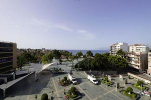 a view of a city with the ocean in the background at Royal Homes 401 in Antalya