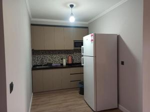 a kitchen with a white refrigerator in a room at Royal Homes 401 in Antalya