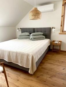a bedroom with a large bed with a gray headboard at Rugio namai-Rye house in Palanga +37 photos