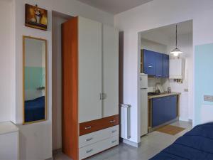 a room with a bedroom with a bed and a kitchen at Filicudi in Torre Forte +3 photos