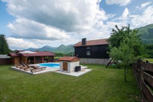 a backyard with a house and a swimming pool at Holiday Home Nina with a heated pool in Brušane