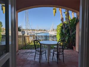 a table and chairs on a patio with a view of the water at Filicudi in Torre Forte
