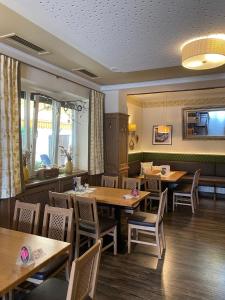 a dining room with wooden tables and chairs at Gasthof zur Post in Soding