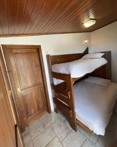 2 łóżka piętrowe w pokoju z drzwiami w obiekcie Oliventu - Tra gli ulivi sul mare w mieście Leuca