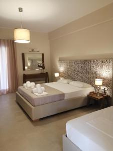 a large bedroom with a large bed and a mirror at Dafni studios no8 in Parga