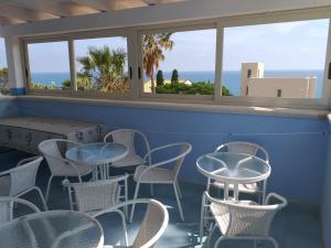 a room with tables and chairs and a window at Villa Azzurra ScaladeiTurchi in Realmonte