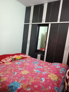 a bedroom with a bed with a pink blanket at Citrus Home in Bengaluru +16 photos