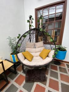 a hanging chair with pillows in a room at banana hostel in Bogotá