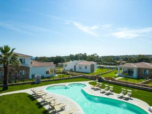 a swimming pool with lounge chairs in a yard at ENAJA - Luxury Retreat in Budoni