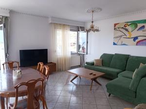 a living room with a green couch and a table at Villa Skala Marion (Michalis) in Skala Marion