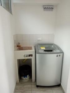 a small kitchen with a sink and a dishwasher at Apartamento STYLE 2 in San Luis