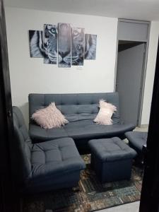 a living room with a couch and two pillows at Apartamento STYLE 2 in San Luis
