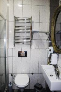 a bathroom with a toilet and a sink and a mirror at Grand Onur Hotel in Istanbul