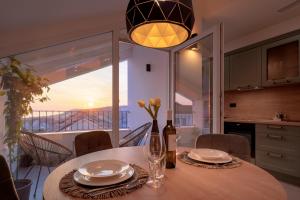 a dining room table with a view of the ocean at Hvar town - Elegance & Brand New in Hvar