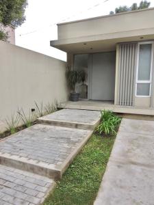 a house with a walkway in front of it at La Casita Amaia in Yerba Buena