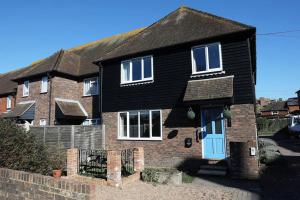 a black brick house with a blue door at 1 Regent Square, Rye - for a perfect break in Rye