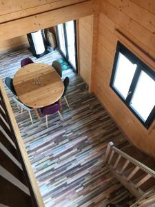 an overhead view of a table and chairs in a cabin at Forest Jura Lodge - Chalet de la Vache in Alièze