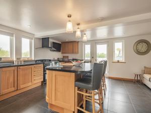 a kitchen with a large island in the middle at Broad View in South Walsham